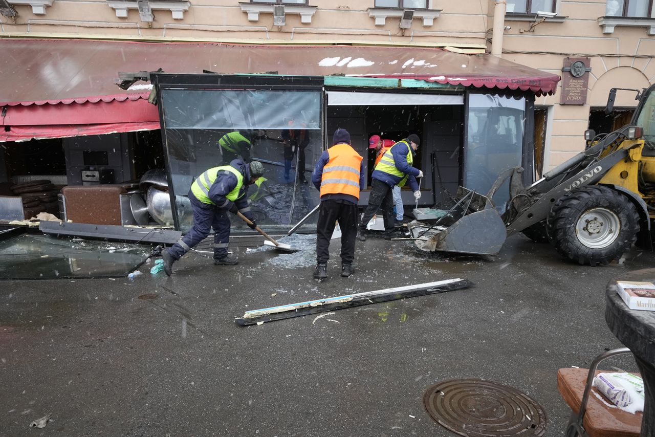 Municipal workers clean an area near the site of an explosion at the "Street Bar" cafe in St. Petersburg, Russia, on April 3.