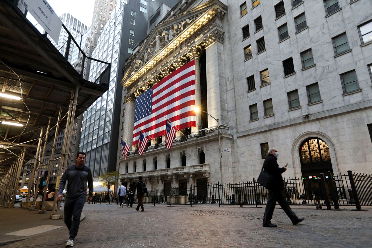 Pedestrians walk past the New York Stock Exchange in New York City, on Monday, November 9