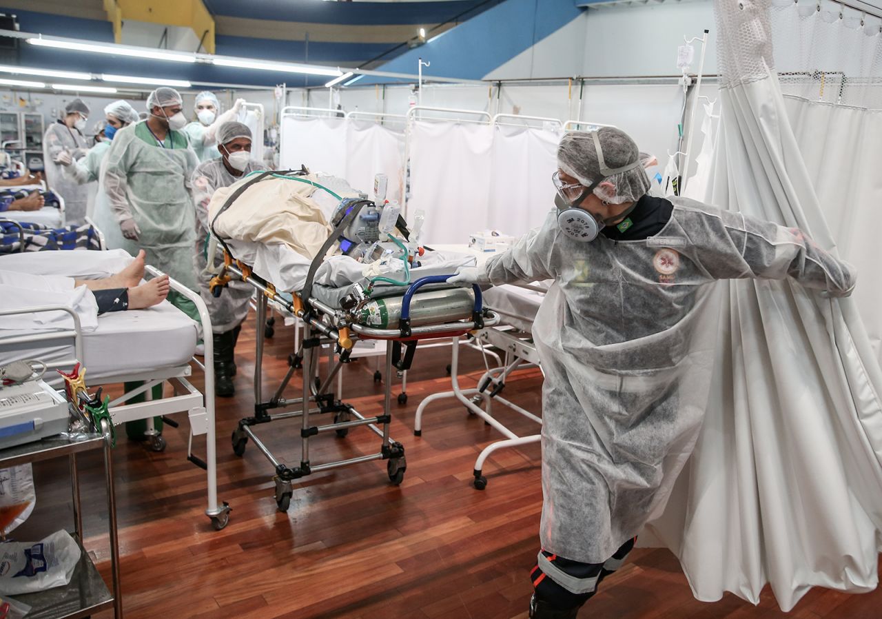 Medical staff members transport a patient on a stretcher at the Pedro DellAntonia Sports Complex field hospital in Santo Andre, Brazil, on March 11.