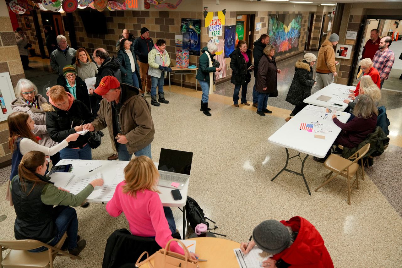 People queue at a caucus site at Fellows Elementary School as voters get ready to choose a Republican presidential candidate in Ames, Iowa, on Monday.