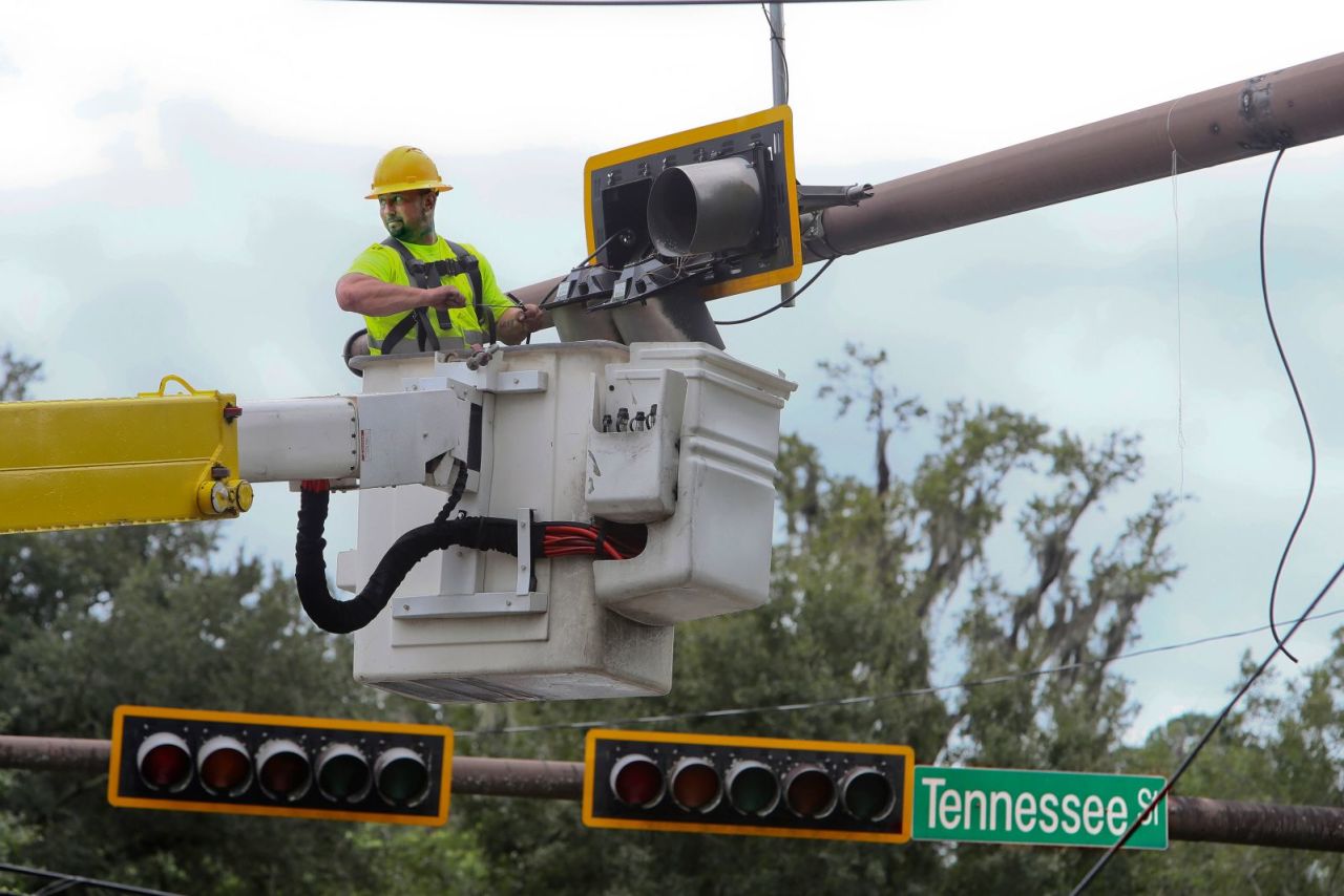 A City of Tallahassee electrical crew member works to repair a street light in Tallahassee, Florida, on August 30. 