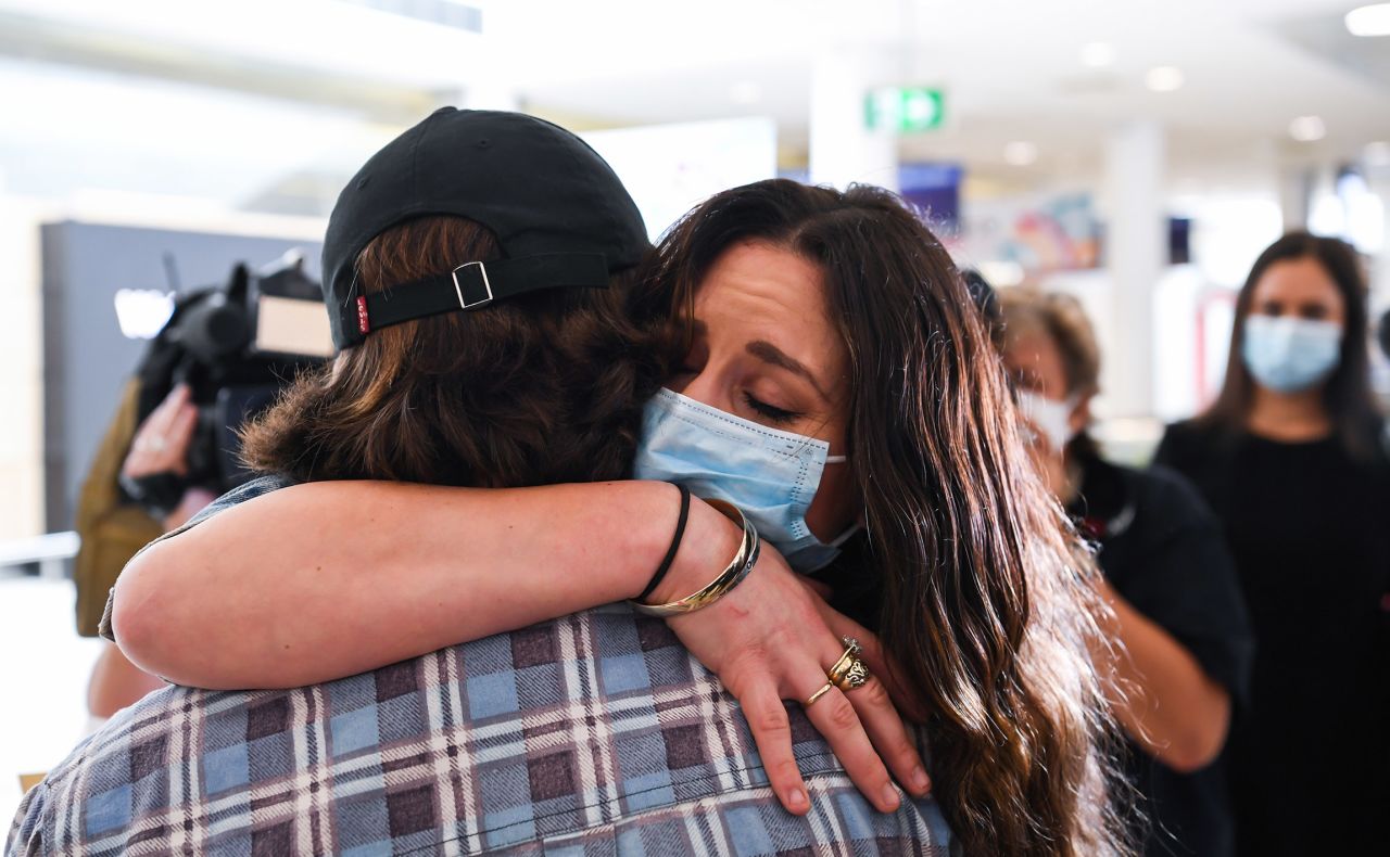 A woman hugs her loved one after arriving at Sydney's Kingsford Smith Airport on an Air New Zealand flight from Auckland on October 16.