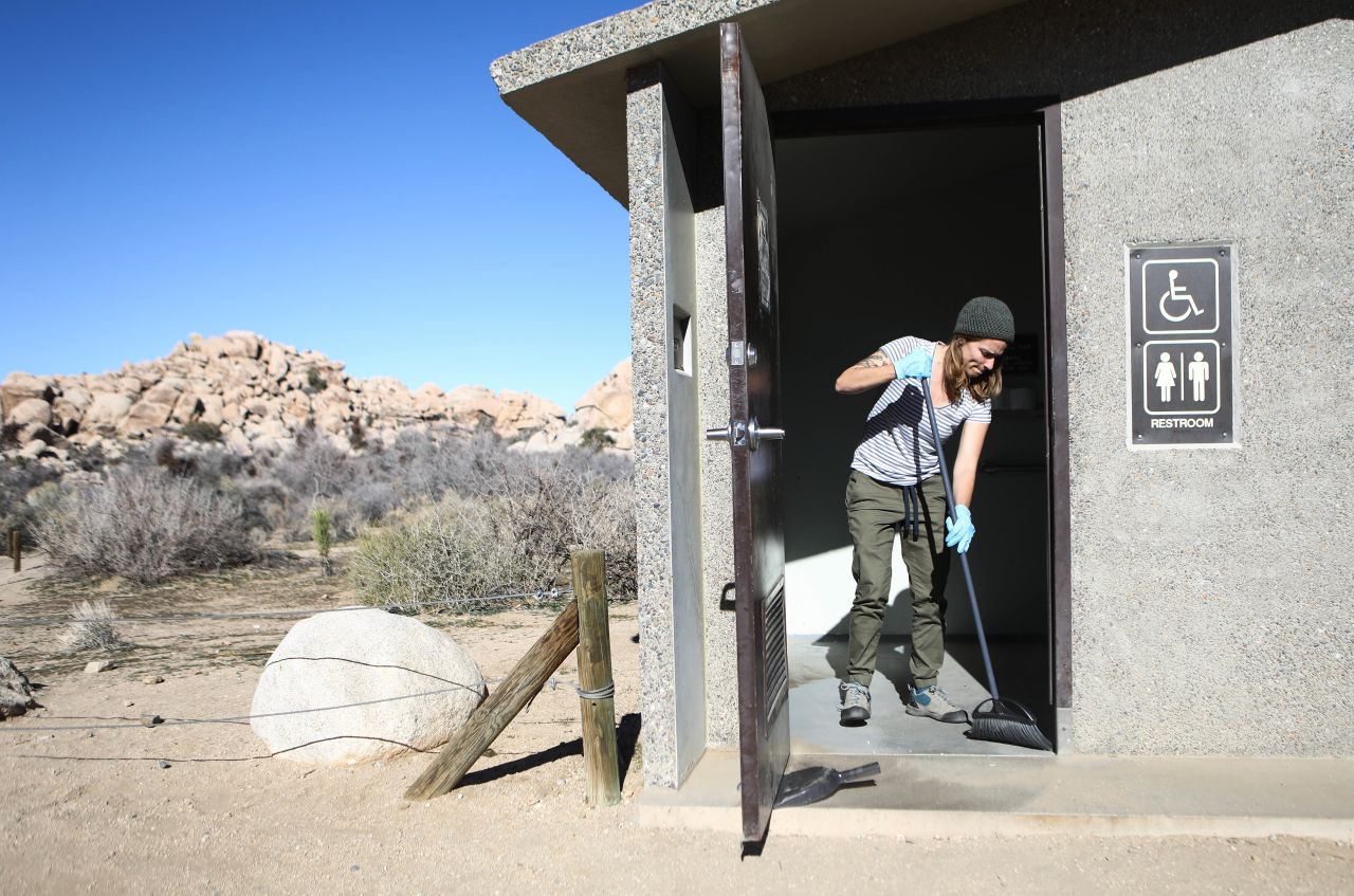 Volunteer Alexandra Degen cleans a restroom at Joshua Tree National Park on January 4. The National Park Service has now said it will tap into visitor fees to keep parks running through shutdown.