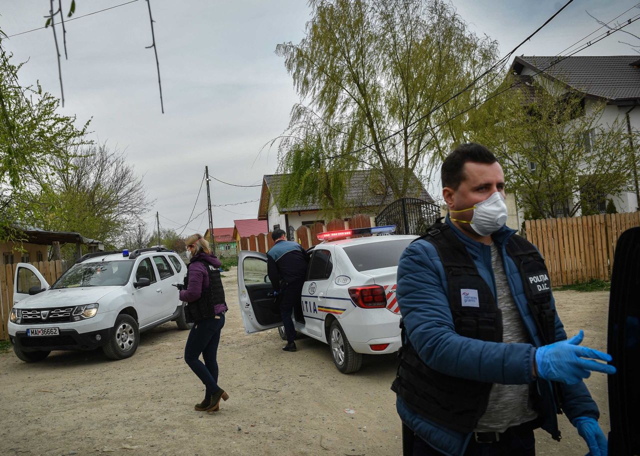 Police reinforce a lockdown curfew in Tandarei, Romania, on April 4.