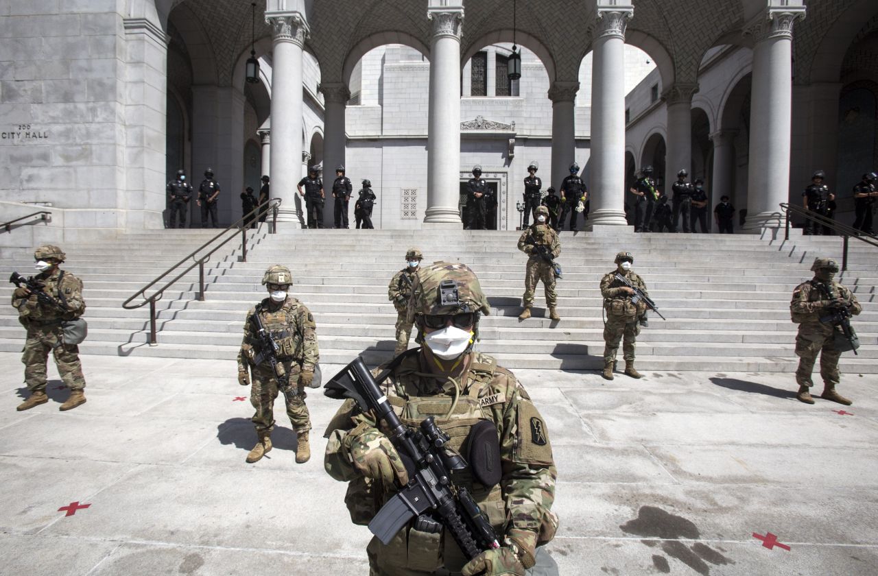 Members of California National Guard stand outside the City Hall, Sunday, May 31, in Los Angeles. 