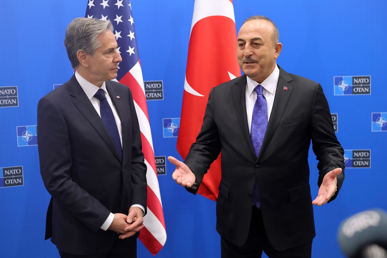 Turkish Foreign Minister Mevlut Cavusoglu, right, speaks with US Secretary of State Antony Blinken at NATO headquarters in Brussels, on Tuesday, April 4.