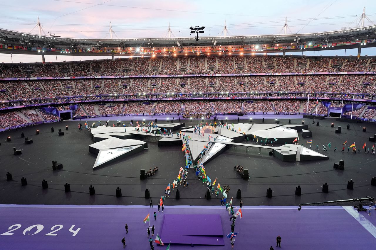 Flag bearers arrive on the pitch at the Stade de France. 