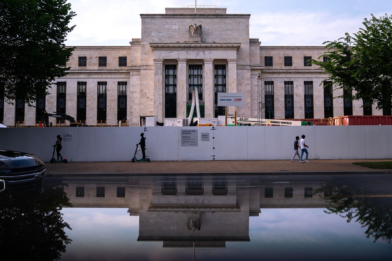 Pedestrians pass the Marriner S. Eccles Federal Reserve building in Washington, DC, on June 3.