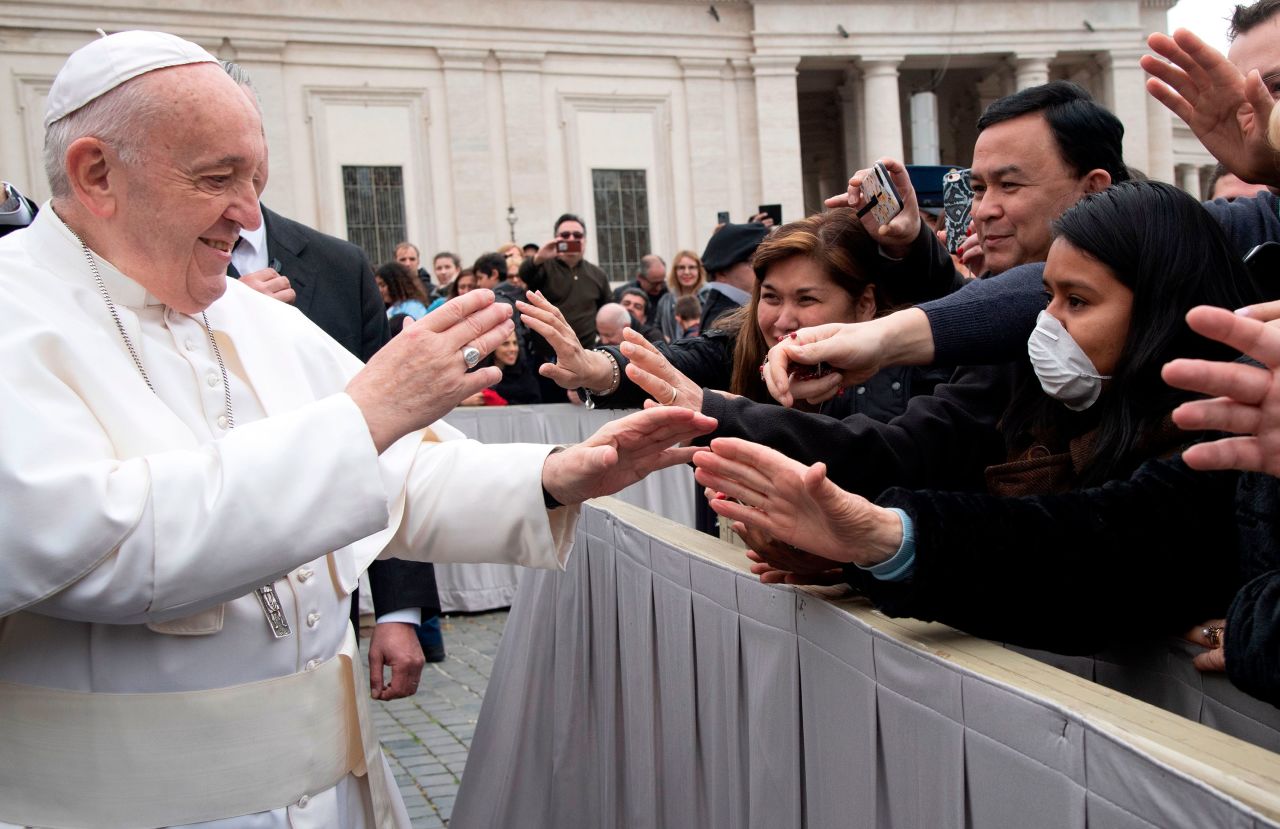 Pope Francis greets people at St. Peter's Square in the Vatican at the end of his weekly general audience on Wednesday, February 26.