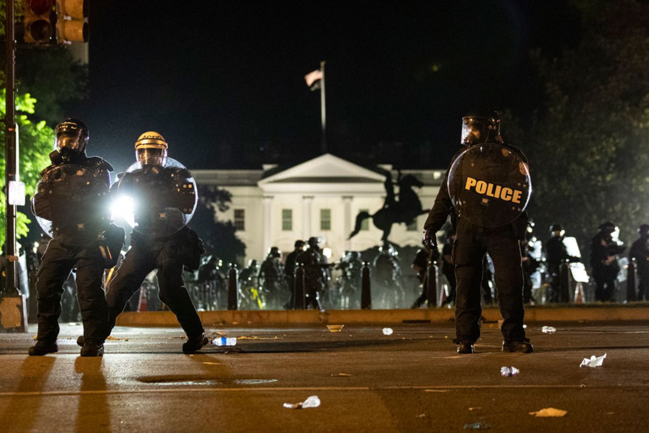 Police form a line on H Street as demonstrators gather to protest the death of George Floyd, Sunday, May 31, 2020, near the White House in Washington. 