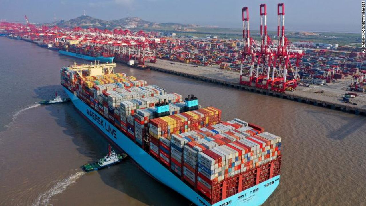 Tugboats guide a container ship at the Yangshan Deepwater Port, Shanghai.