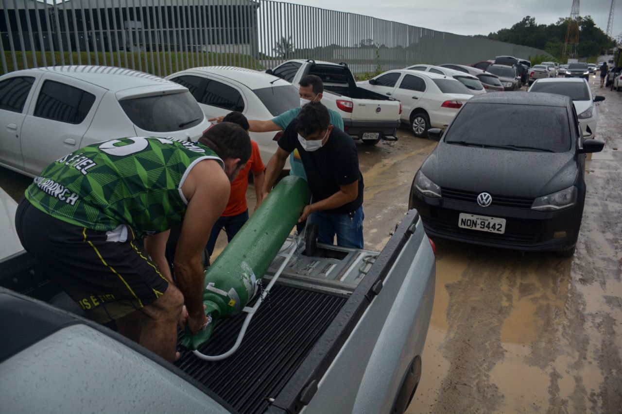 Relatives of patients infected with Covid-19 leave after queueing for long hours to refill their oxygen tanks at the Carboxi company in Manaus, Amazonas state, Brazil, on Tuesday.