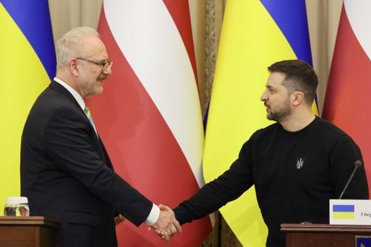 Ukrainian President Volodymyr Zelensky and?Latvian?President?Egils Levits shake hands during a joint news briefing, in Lviv, Ukraine on Friday.