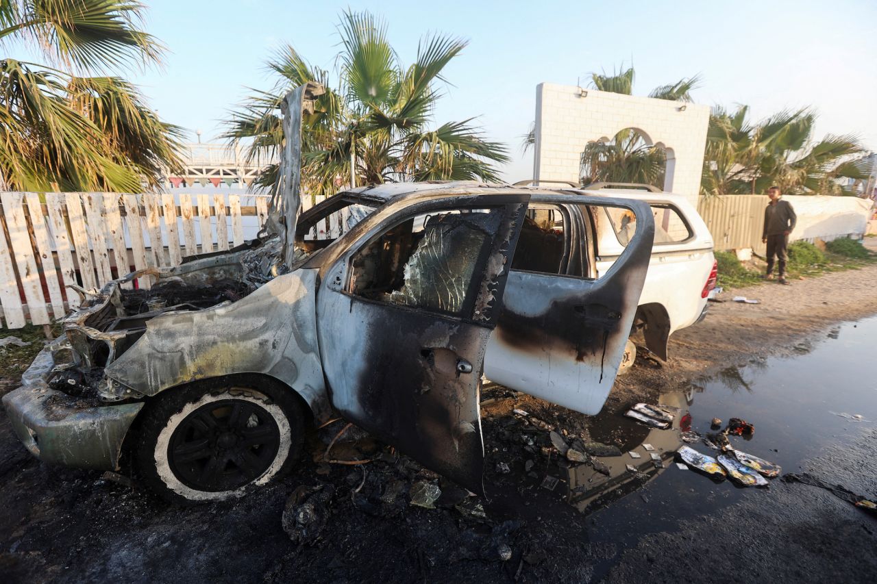 A person looks at a vehicle where employees from the World Central Kitchen were killed in an Israeli airstrike, in Deir Al-Balah, central Gaza, on April 2.