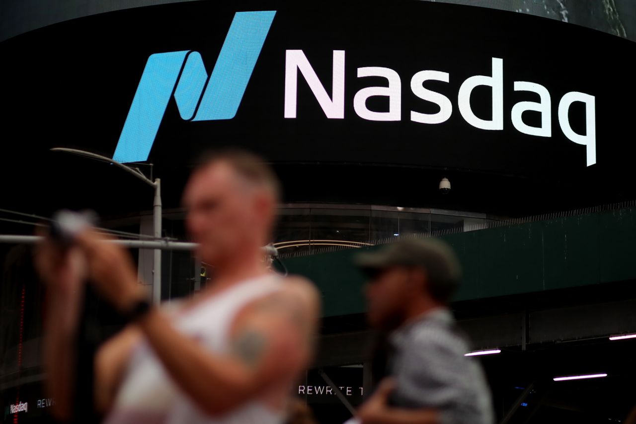 People walk near Nasdaq MarketSite at Times Square on July 12 in New York City.?