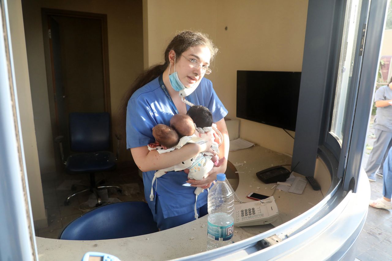 A nurse in Beirut takes care of three babies in a damaged hospital on August 4.