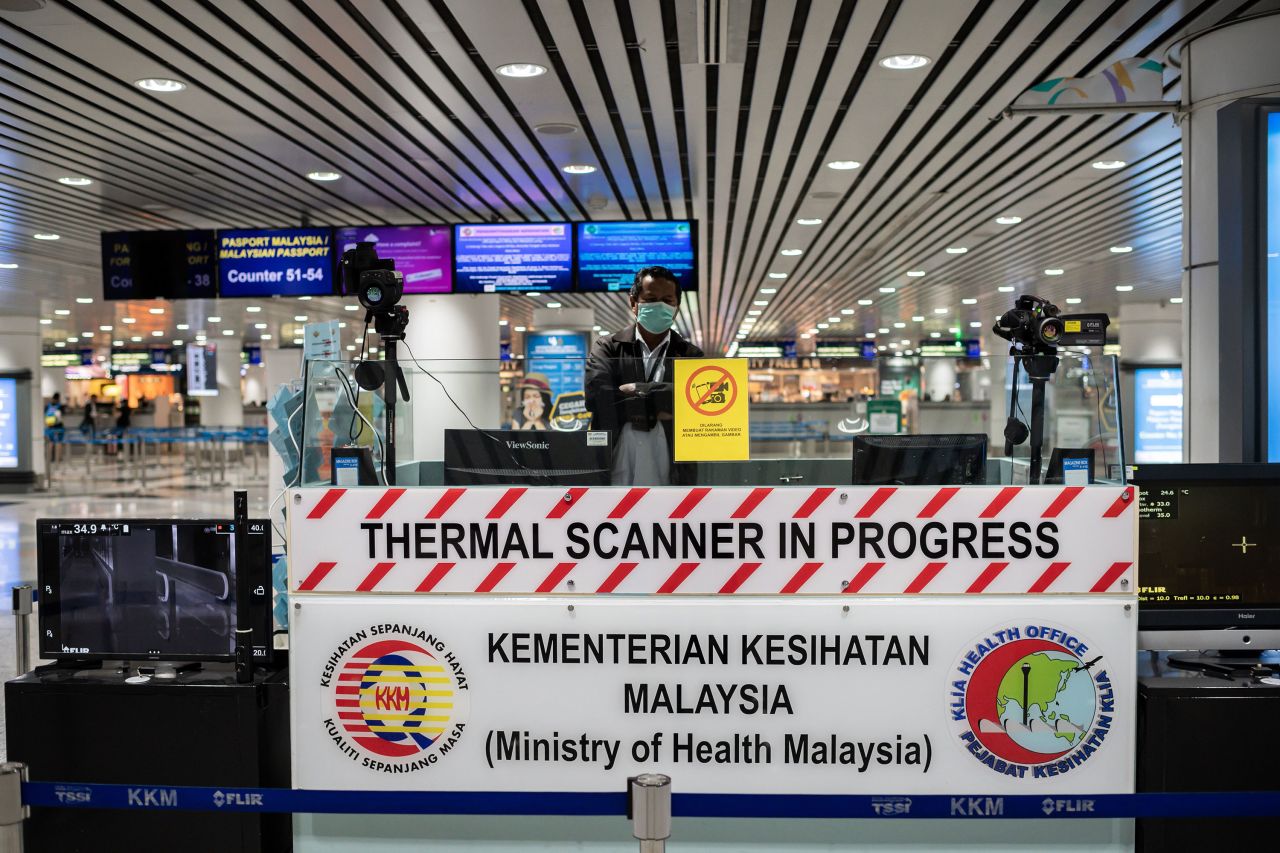 A security officer stands at a thermal scanner area at the Kuala Lumpur International Airport in Malaysia on February 13.