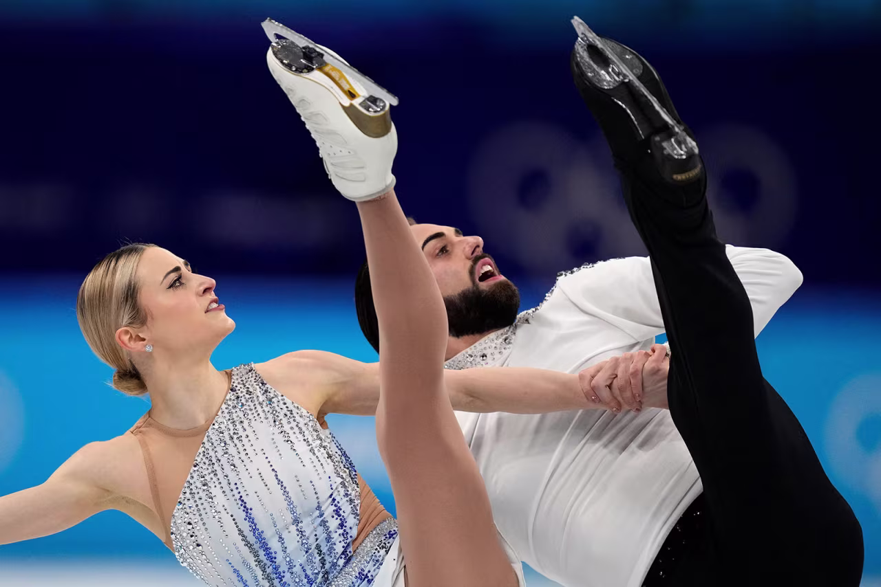 American figure skating duo Ashley Cain-Gribble and Timothy LeDuc skate in the pairs short program on February 18. LeDuc became the first openly nonbinary athlete to compete at the Winter Olympics.