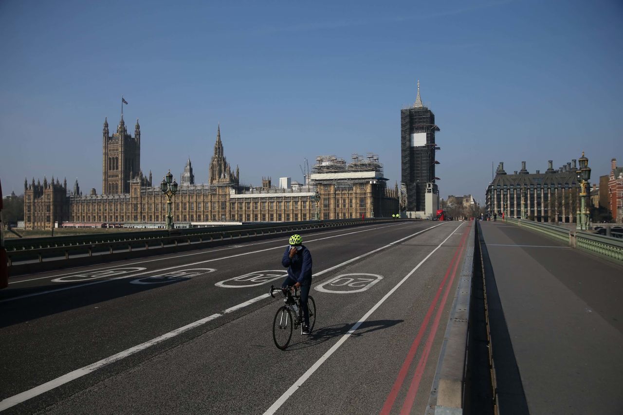 The UK Houses of Parliament are pictured as a cyclist crosses Westminster Bridge in London, England, on April 9.