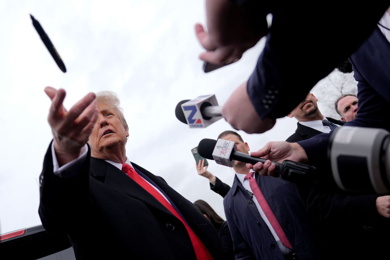 Former President Donald Trump tosses a pen as he addresses members of the press during a campaign stop in Londonderry, New Hampshire, on Tuesday.