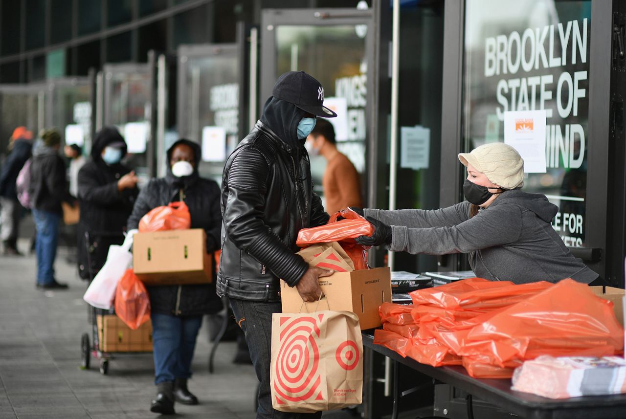 People wait in line at a food bank on the Barclays Center plaza in Brooklyn, New York, on April 24.