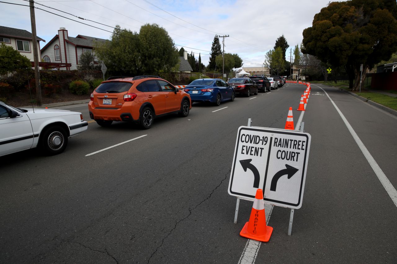 Cars line up to get a Covid-19 test at a free public testing station on March 24, in Hayward, California. 