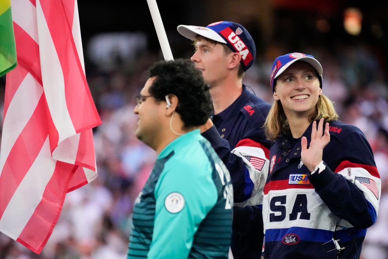 US swimmer Katie Ledecky, serving as a flagbearer alongside Nick Mead, walks into the stadium during the closing ceremony. 