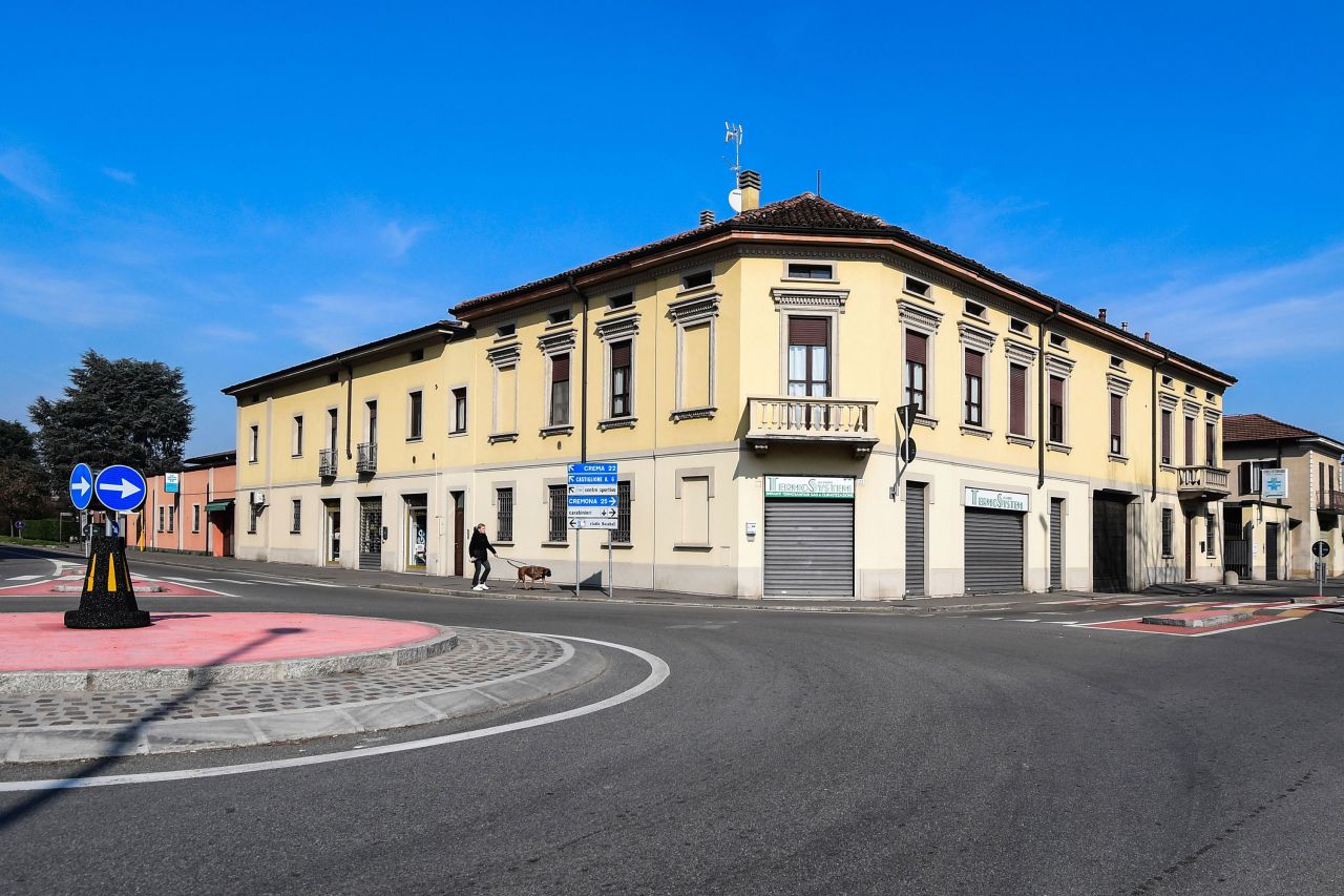 A person walks a dog on an empty street in Codogno, Italy, on February 22.