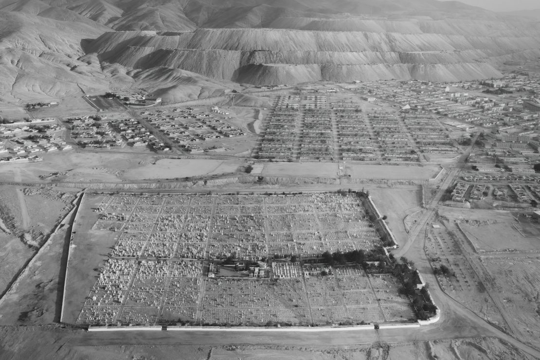 Mineral ore extraction encroaches on an abandoned mining town and cemetery.
