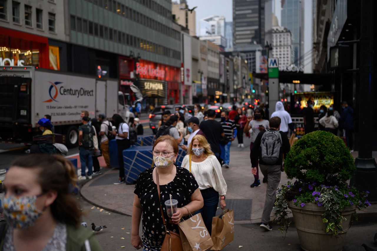 Pedestrians wearing face masks pass along a street in Manhattan, New York on June 3.