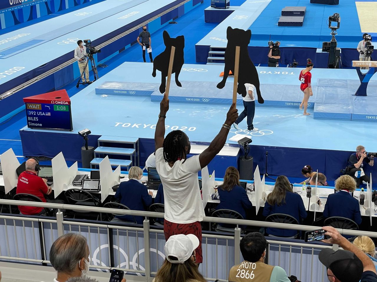 Evans waves the cutouts for Biles.