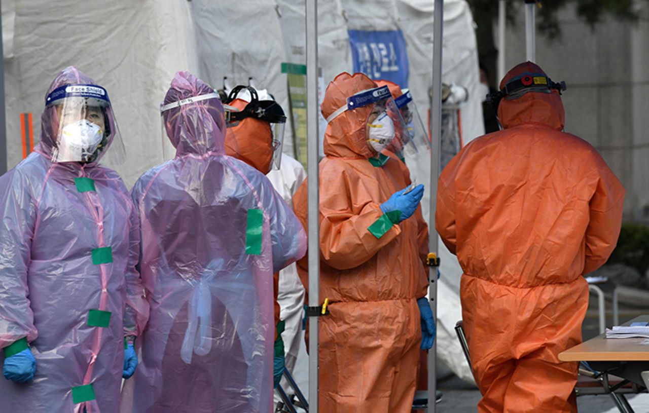 Medical staff members wait for people with suspected symptoms of the novel coronavirus, at a testing facility in Seoul on Wednesday, March 4. 