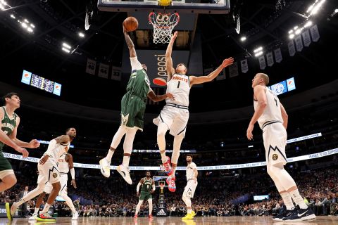 Sterling Brown #23 of the Milwaukee Bucks dunks over Michael Porter Jr. #1 of the Denver Nuggets at the Pepsi Center in Denver, in March 9. 