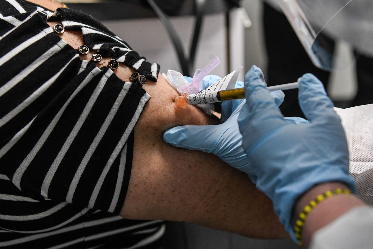 Sandra Rodriguez, 63, receives a Covid-19 vaccination from Yaquelin De La Cruz at the Research Centers of America (RCA) in Hollywood, Florida, on August 13.