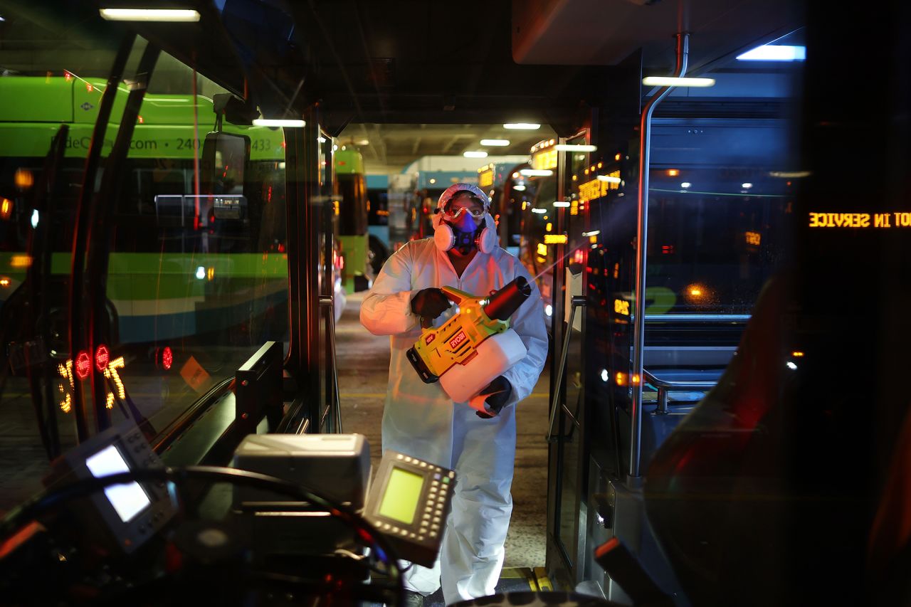 A worker disinfects public buses at the Montgomery County Division of Fleet Management Equipment Maintenance and Transit Operation Center March 20 in Rockville, Maryland.