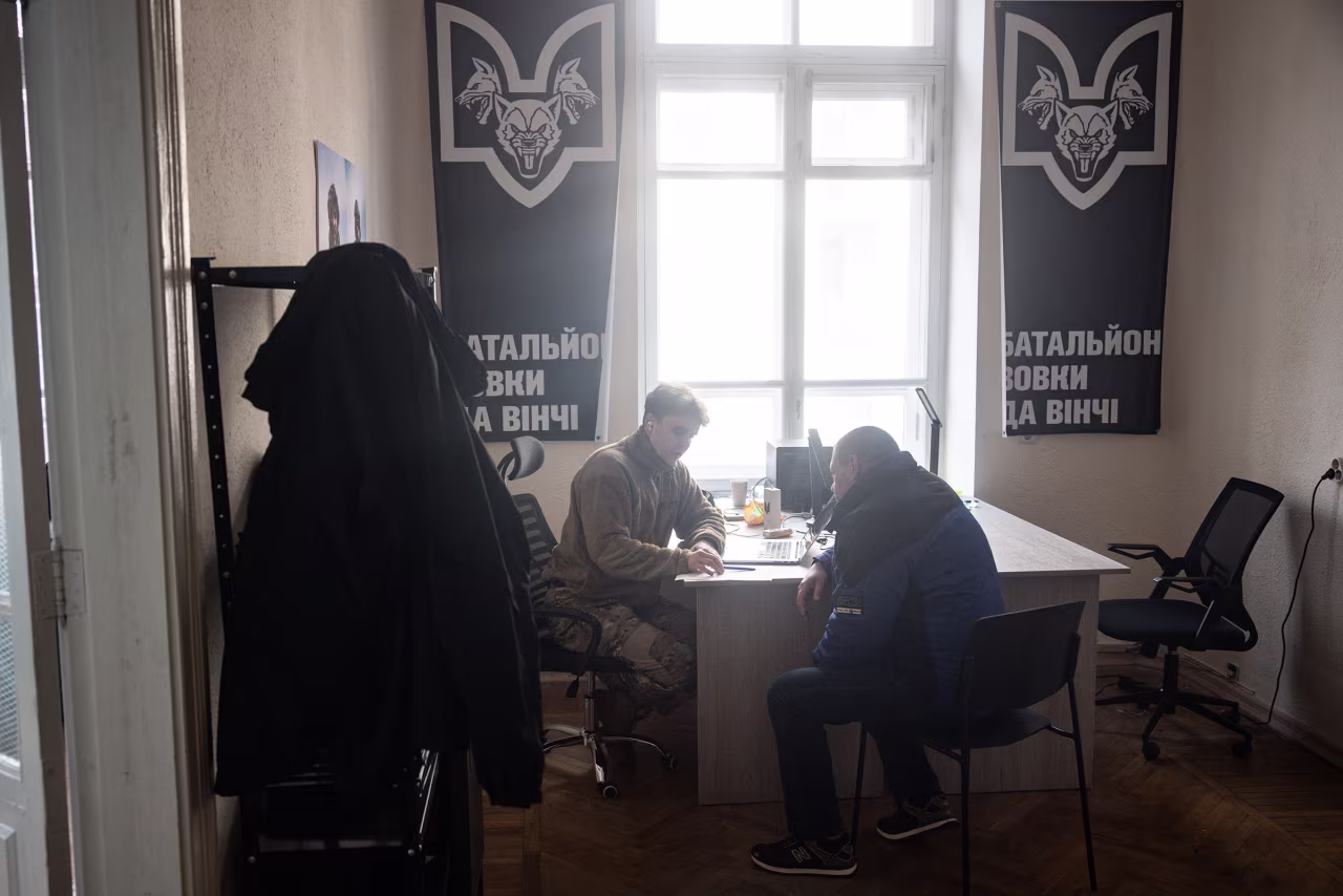 Max, a recruitment officer for the DaVinci Wolves Battalion, talks with 39 year-old Mykhailo during his recruitment interview at a recruitment office on February 22, in Kyiv, Ukraine. 