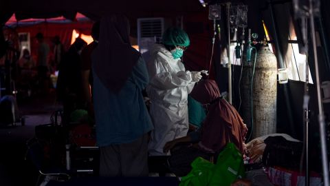 Covid-19 patients get treatment in an emergency tent at Bekasi General Hospital on July 18 in Bekasi, Indonesia. 