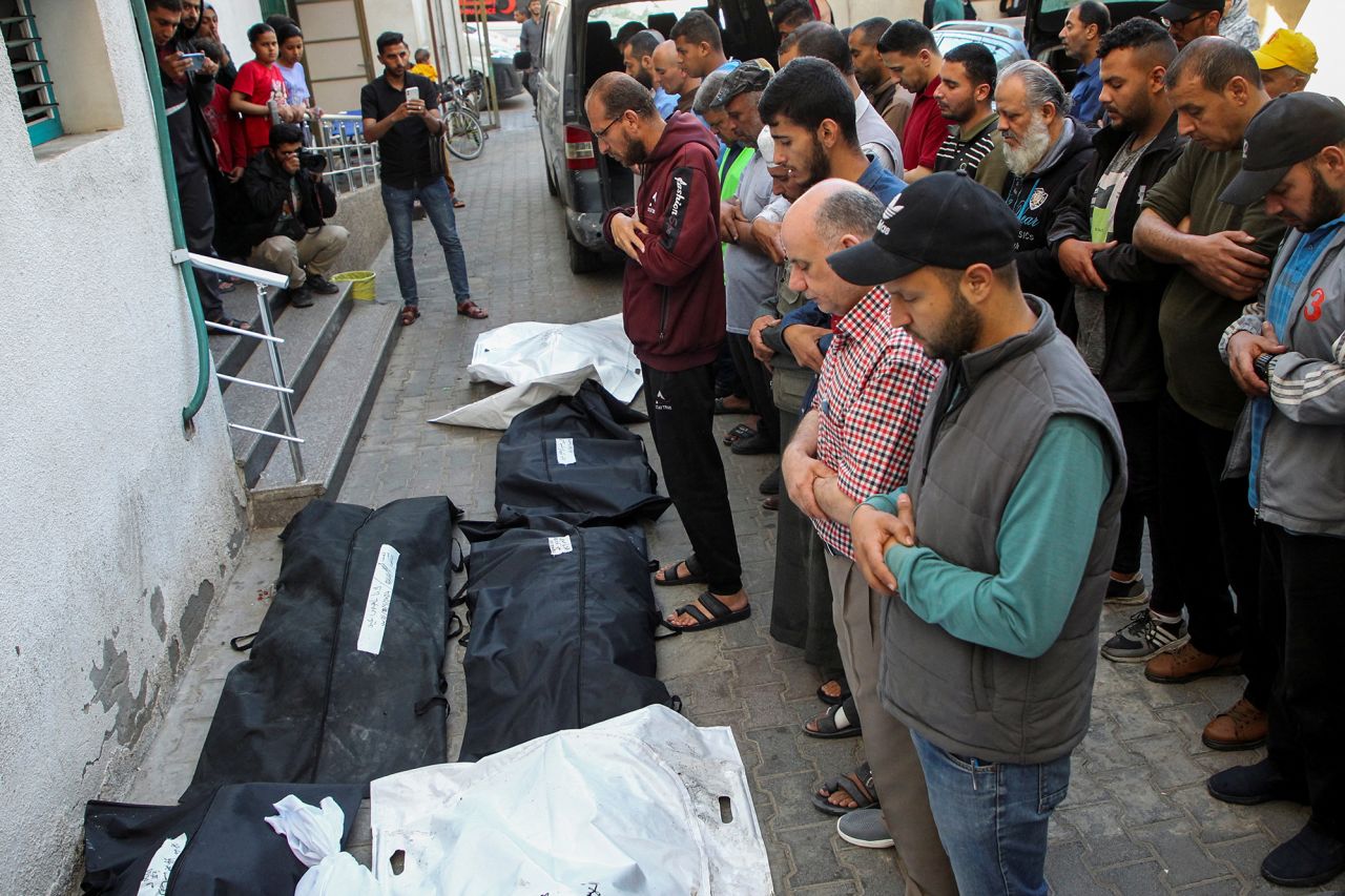 Mourners pray next to the bodies of Palestinians killed in Israeli strikes during their funeral in Rafah, Gaza, on May 9.