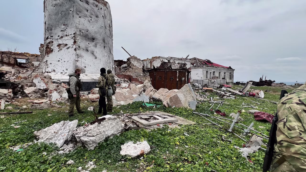 Ukrainian soldiers in front of the remains of the lighthouse of Zmiinyi island aka 'Snake island'