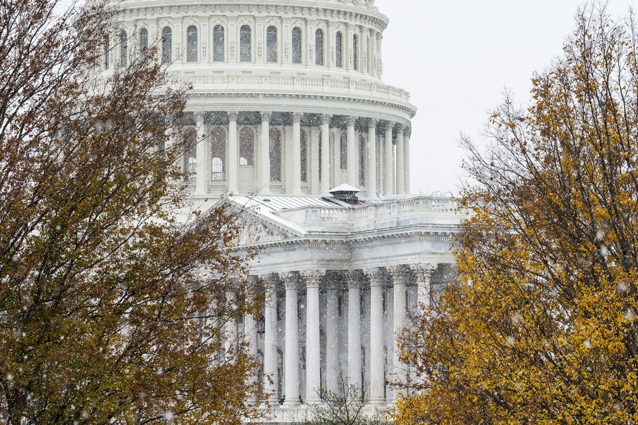 Snow falls in front of the US Capitol in Washington, DC, on December 16.