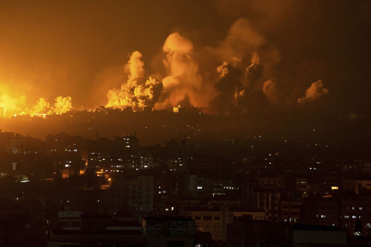 Fire and smoke rise following an Israeli airstrike in Gaza City on Sunday.