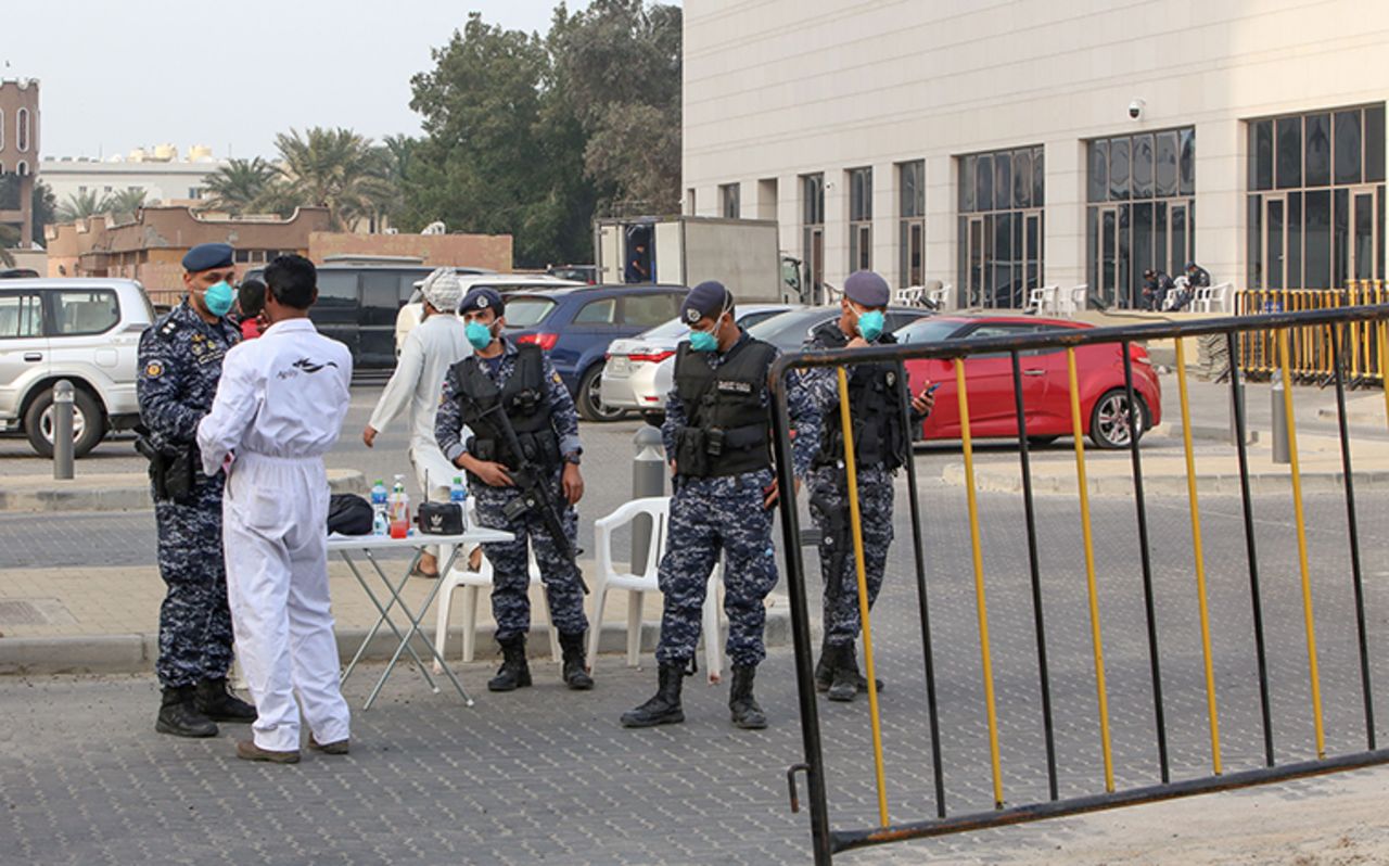 Members of Kuwait's national guard wear safety masks as they keep watch outside a hotel in the capital where Kuwaitis returning from Iran are quarantined and tested for the virus, on Monday, February 24.