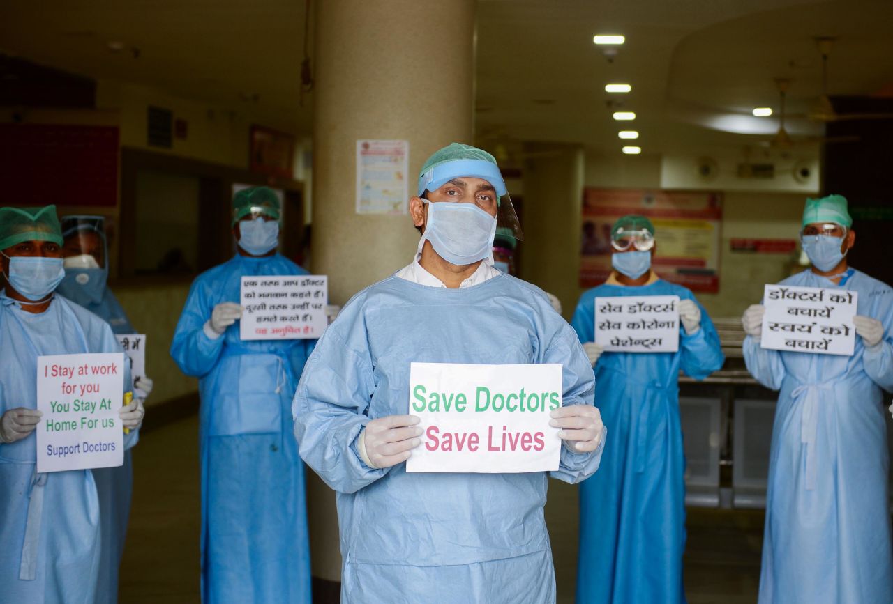 Doctors and medical staff of Narayan Swaroop Hospital in Allahabad hold placards on April 16 to protest against recent assaults on health care workers in India.