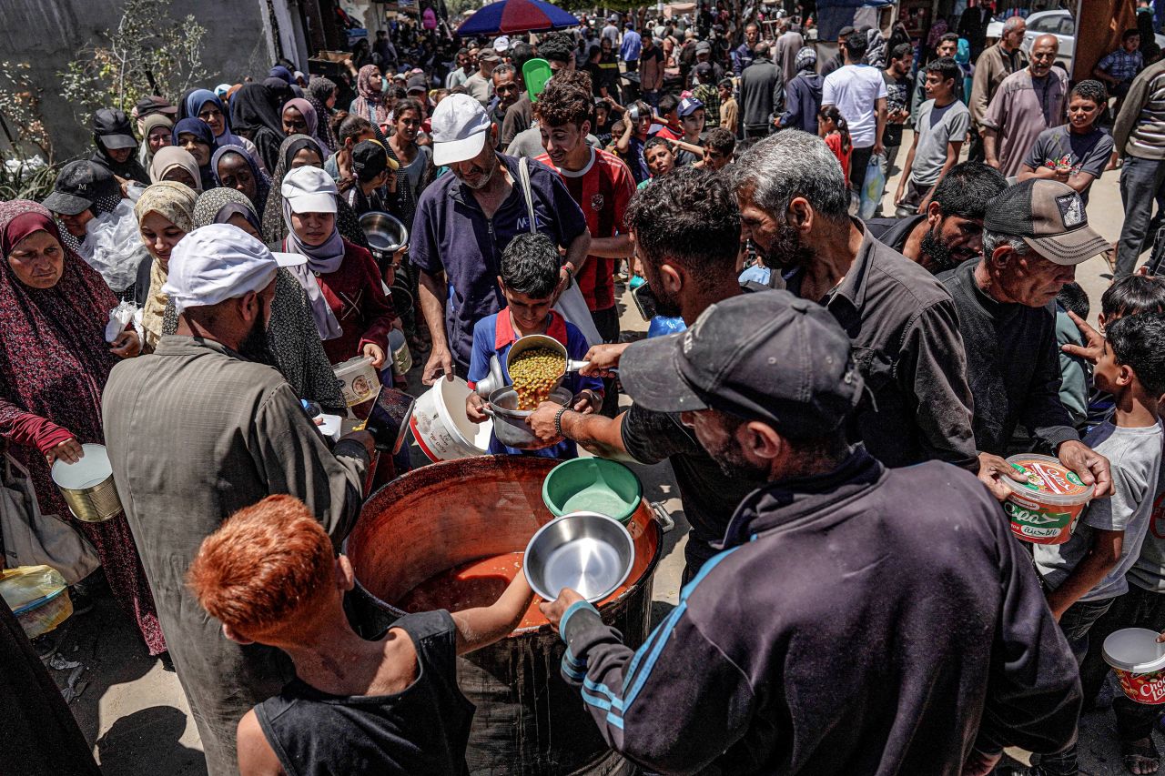People receive food from a public kitchen in Deir al-Balah, Gaza, on May 13.