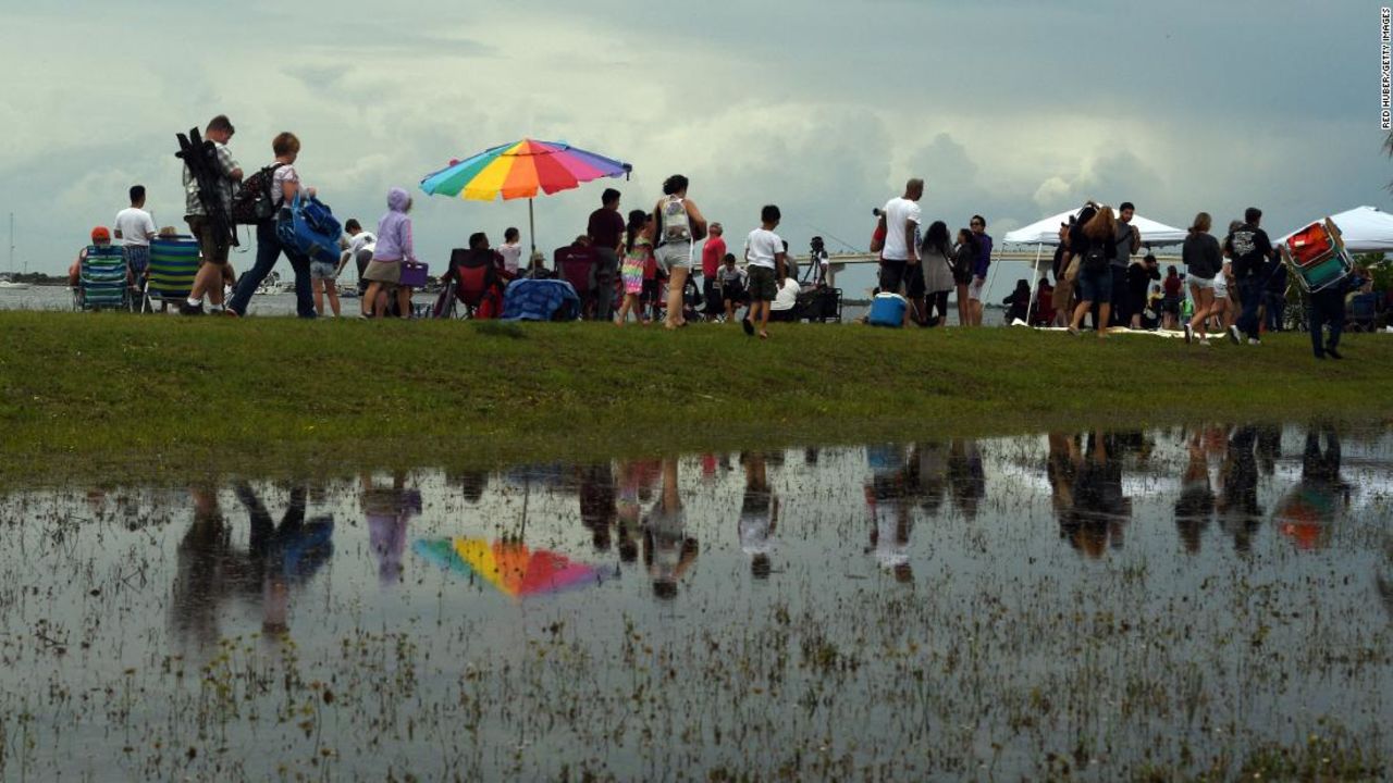 People who had gathered to watch Wednesday's SpaceX launch leave Marina Park in Titusville, Florida after it was scrubbed.