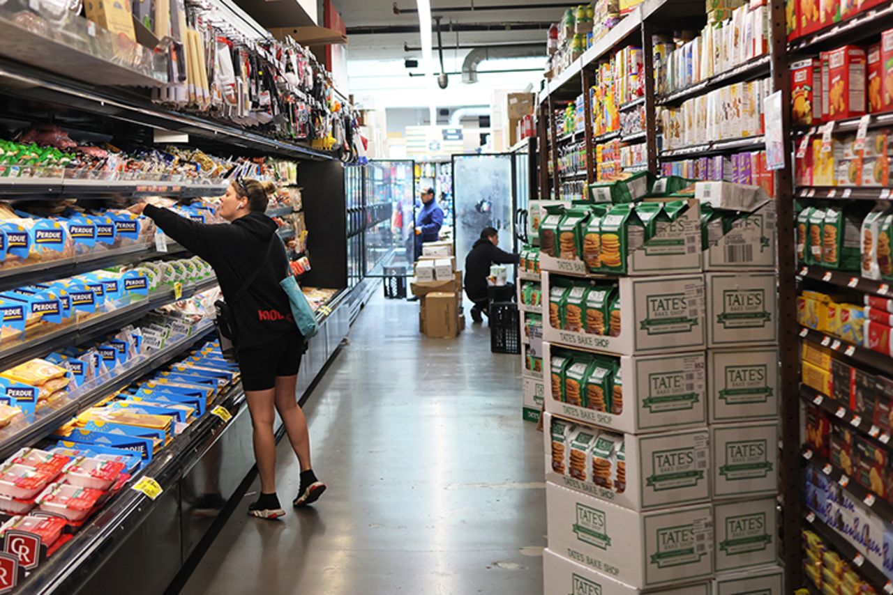 People shop at a neighborhood grocery store in Brooklyn, New York, on June 12.