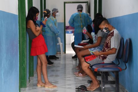 Brazilian indigenous people of the Marubo ethnic group wait to see doctors from the Brazilian Armed Forces' medical team at a health post in Amazonas state. 