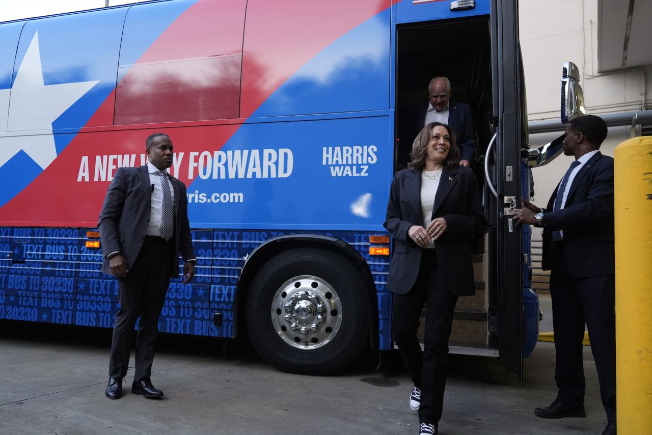 Vice President Kamala Harris and her running mate, Minnesota Governor Tim Walz, exit their campaign bus in Savannah, Georgia, on August 28.