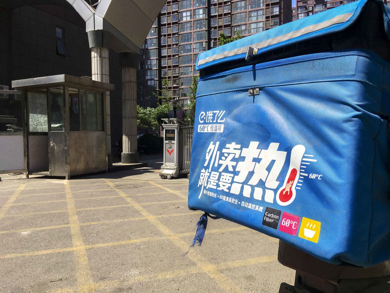 A motorcycle for take-out delivery service Ele.me is seen parked in a residential district of Beijing, in May 2017.