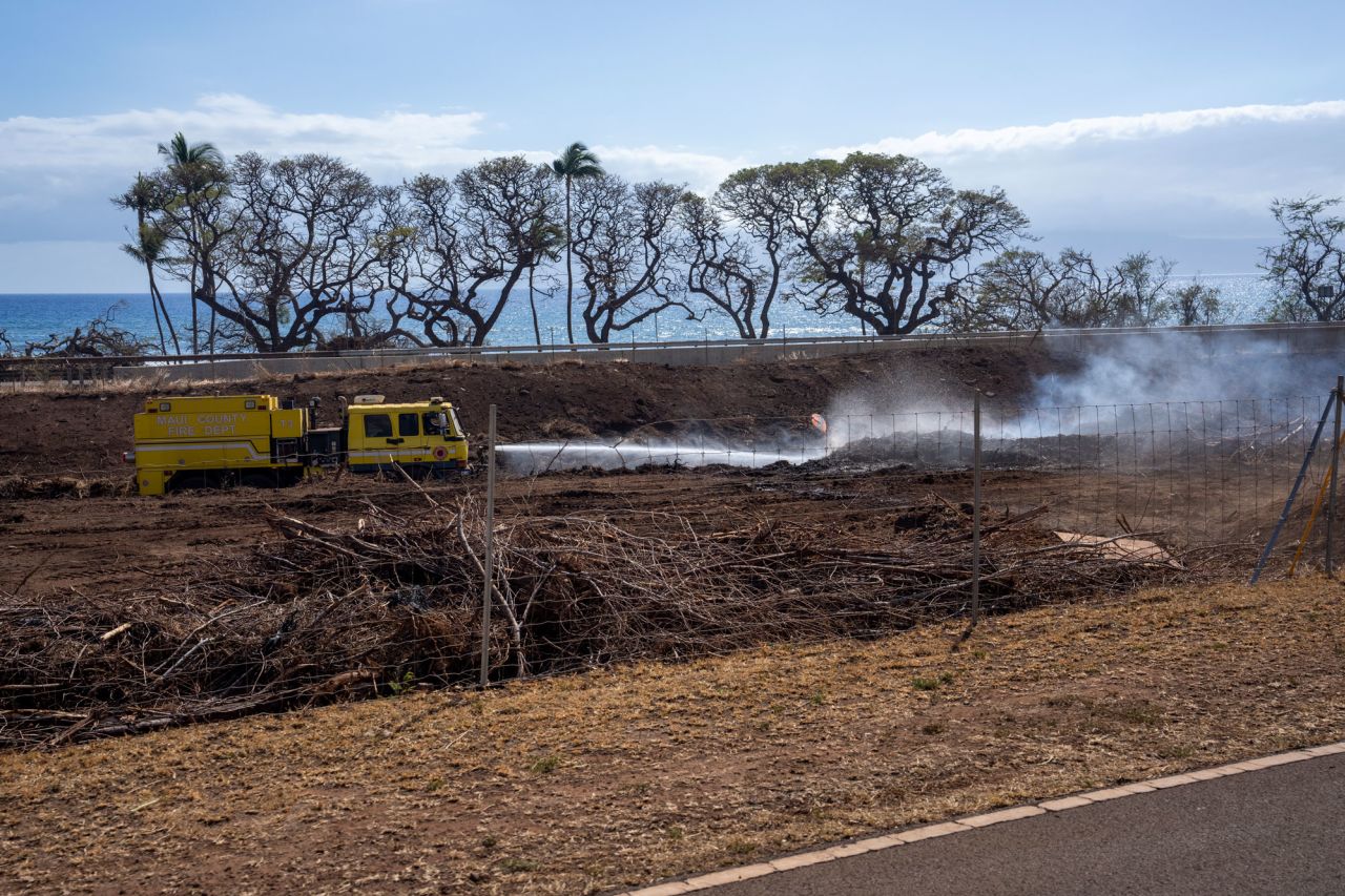 A Maui County Fire Department truck puts out remaining flames in Lahaina, Hawaii, on August 10, 2023.